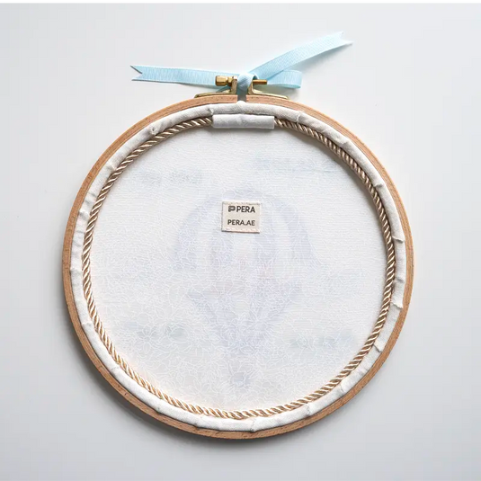 Customized baby boy name hoop with blue hot air balloon embroidery for a newborn gift, backside finished with a cotton fabric and a rope to give it more luxury feeling